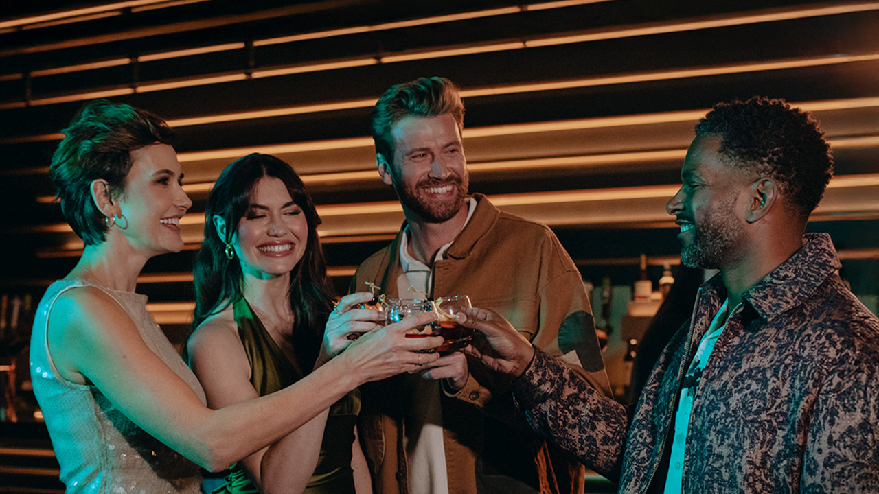 a group of people enjoying drinks in a lounge